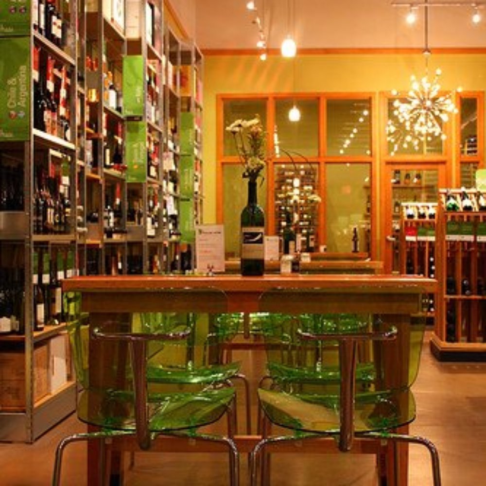 a wine shop with green chairs