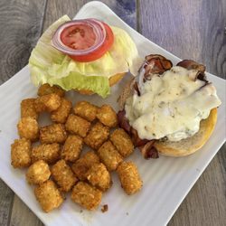 The Comfy Belly - Bacon cheeseburger with pepper jack cheese, lettuce, tomato and red onions with crispy tater tots.