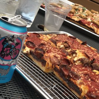 Underground Pizza - Tiger King and chicken parm pizza in the back - Pizza Near Me - Baltimore, Maryland