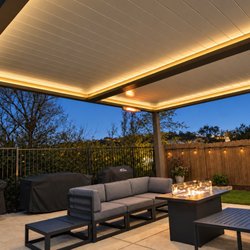 Pristine Patio - Evening lounge beneath a warm illuminated patio cover.
