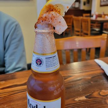 Mariscos Puerto Nuevo - a bottle of beer on a table - Mexican Near Me - Seaside, California Mariscos Puerto Nuevo - a bottle of beer on a table - Mexican Near Me - Seaside, California
