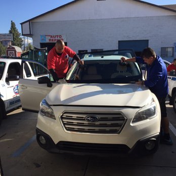 All Class Auto Glass - Juan and one of his staff placing the new window in - Auto Glass Services Near Me - Azusa, California