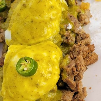 Broken Yolk Cafe - Border Benedict with carne asada, poblano sauce, & poached eggs atop corn cakes. - Breakfast & Brunch Near Me - Costa Mesa, California Broken Yolk Cafe - Border Benedict with carne asada, poblano sauce, & poached eggs atop corn cakes. - Breakfast & Brunch Near Me - Costa Mesa, California