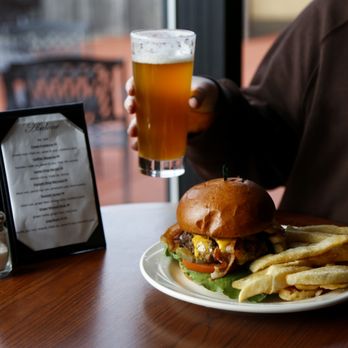 Abalone Bar & Grill - a man holding a glass of beer and a plate of food - New American Near Me - Klamath, California Abalone Bar & Grill - a man holding a glass of beer and a plate of food - New American Near Me - Klamath, California