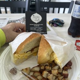 egg, meat and cheese on a bun, plus home fries which didnt look that great but with salt and ketchup were pretty good; egg, meat and cheese on a bun, plus home fries which didnt look that great but with salt and ketchup were pretty good;