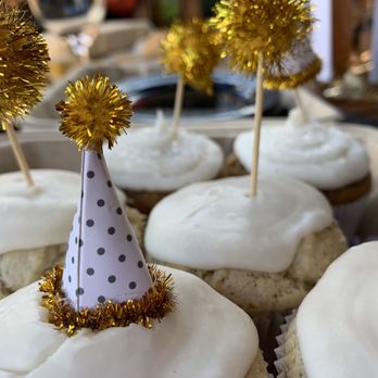 Hidden Lotus Bakeshop - cupcakes with white frosting and a party hat - Gluten-Free Near Me