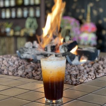 Malakor Thai Restaurant - a cold drink on a table in front of a fire pit - Thai Near Me - Renton, Washington Malakor Thai Restaurant - a cold drink on a table in front of a fire pit - Thai Near Me - Renton, Washington