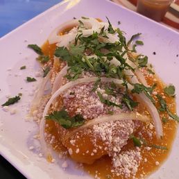 Chicken Empanada: homemade masa stuffed with marinated chicken covered in a sweet and savory orange bell pepper salsa/sauce. Chicken Empanada: homemade masa stuffed with marinated chicken covered in a sweet and savory orange bell pepper salsa/sauce.