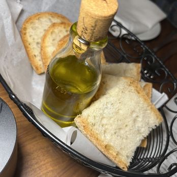 Tramonto Restaurant - a bottle of olive oil and bread - Italian Near Me - Hawthorne, New York Tramonto Restaurant - a bottle of olive oil and bread - Italian Near Me - Hawthorne, New York