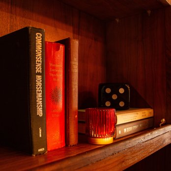 Ojai Pub - a bookshelf with dice and books - Pubs Near Me - Ojai, California Ojai Pub - a bookshelf with dice and books - Pubs Near Me - Ojai, California