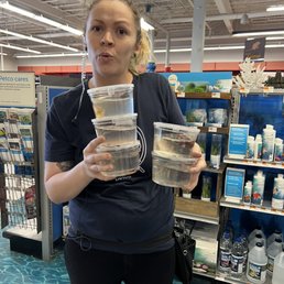 Manager with five of the dead fish we found. My daughter had one in her hand.