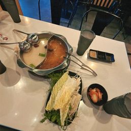 Tonkotsu pork broth (left), and mild spicy mongolian (right), veggies from the bar Tonkotsu pork broth (left), and mild spicy mongolian (right), veggies from the bar