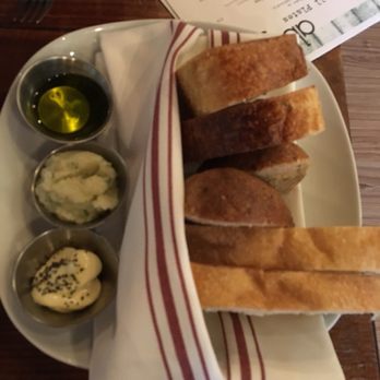 Abejas - Bread basket with some sort of dipping oil, cauliflower garlic spread, and butter with black sesame - New American Near Me - Golden, Colorado