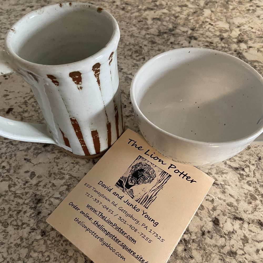 a cup of coffee next to a business card