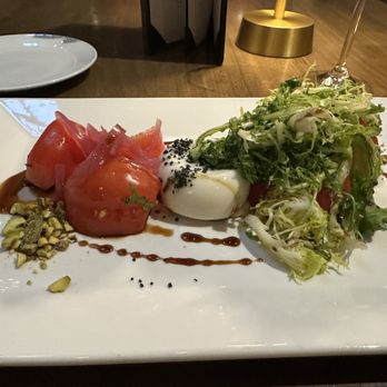 Prado - Heirloom tomato, Burrata Cheese with Himalayan black salt, balsamic reduction, frisée lettuce & pistachios - Spanish Near Me - Paradise Valley, Arizona Prado - Heirloom tomato, Burrata Cheese with Himalayan black salt, balsamic reduction, frisée lettuce & pistachios - Spanish Near Me - Paradise Valley, Arizona