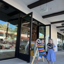 Shout and About - Kids with their silhouette cut outs in front of the Shout and About store.