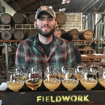 Fieldwork Brewing Co. - Beer flights, brewery space in the background. - Breweries Near Me - Berkeley, California