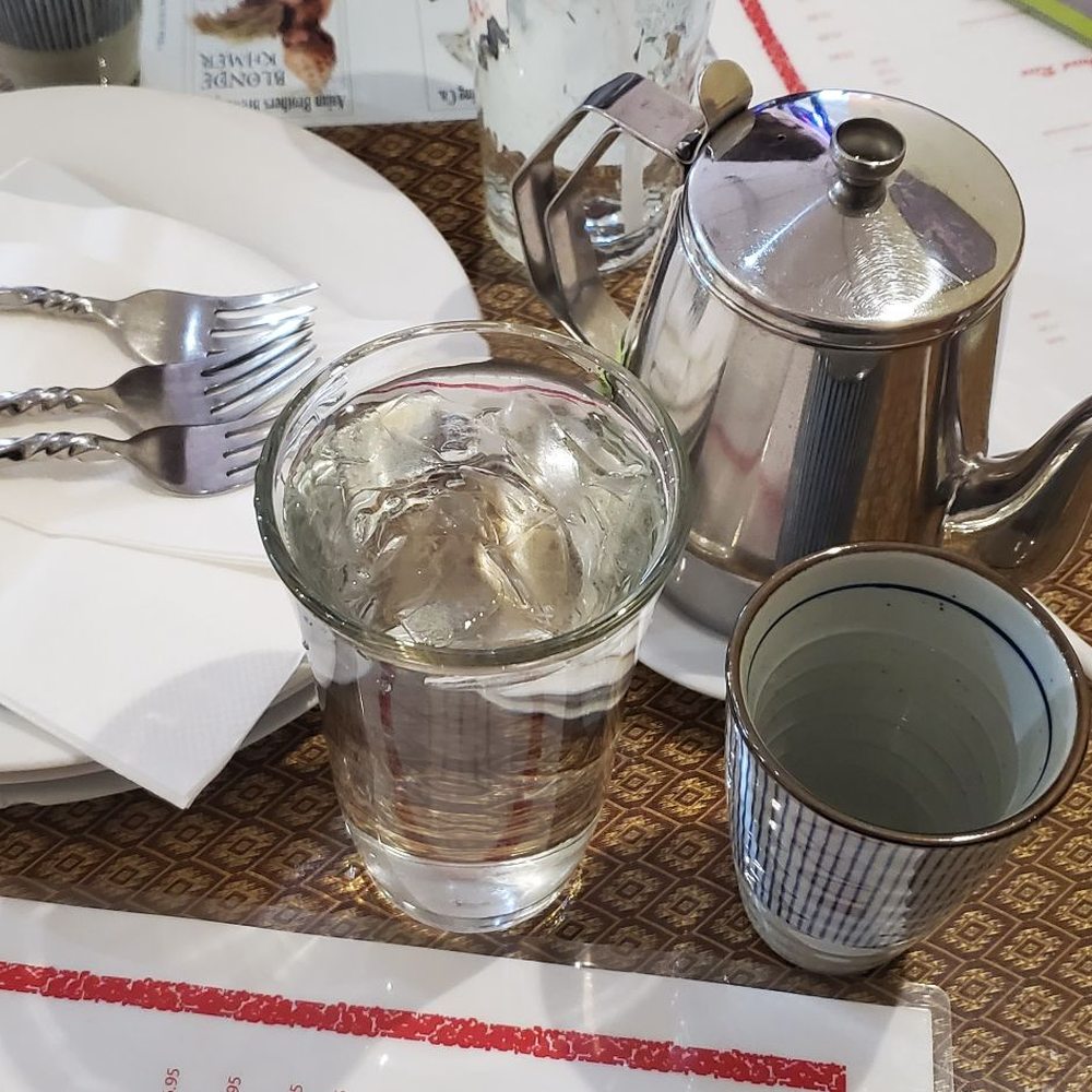 Khun Suda - a table setting with silverware and utensils - Thai Near Me - Roseville, California