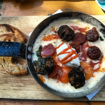Milk - Käsekrainer baked eggs with crispy spinach balls and labneh - Coffee & Tea Near Me - London, XGL