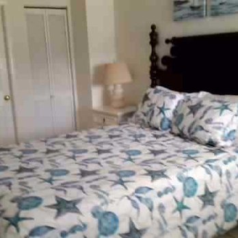 Bodega Harbor Inn - Bedroom at Bodega Harbor Inn.  See the nice bed cover with starfish, clam shells, and kelp (all blue-colored). Also, sea urchin-shaped lamp. - Hotels Near Me - Bodega Bay, California