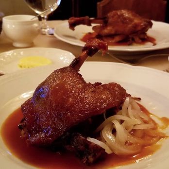 Petit Louis Bistro - Confit de Canard (duck confit, pommes lyonnaise, reduction sauce) - French Near Me - Baltimore, Maryland Petit Louis Bistro - Confit de Canard (duck confit, pommes lyonnaise, reduction sauce) - French Near Me - Baltimore, Maryland
