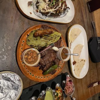 Asadero Prime - Papa Loca on top, La Carne Asada Wagyu plate with a side of quesadillas, and the condiment flight. - Mexican Near Me - Kent, Washington Asadero Prime - Papa Loca on top, La Carne Asada Wagyu plate with a side of quesadillas, and the condiment flight. - Mexican Near Me - Kent, Washington
