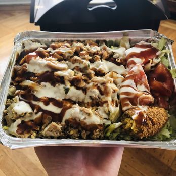 Middle Eastern Halal Food - Chicken over rice with a falafel and salad. White and BBQ sauce - Halal Near Me - Brooklyn, New York