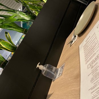 Banana Leaf - a table with a menu and a water bottle - Malaysian Near Me - Vancouver, British Columbia