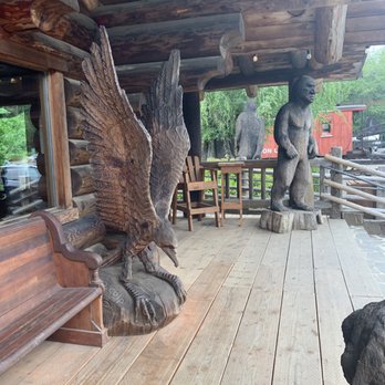 Camp 18 Restaurant - The wood statues on the deck - American Near Me - Seaside, Oregon