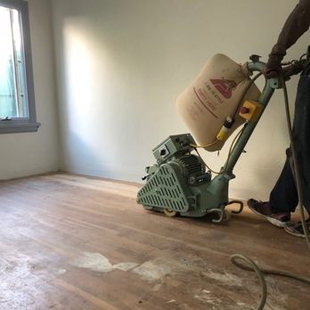 Summit Quality Wood Floors - a man using a machine - Flooring Near Me Summit Quality Wood Floors - a man using a machine - Flooring Near Me