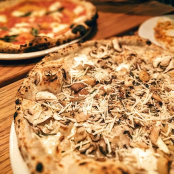 Pizzeria Libretto - two pizzas on a wooden table - Pizza Near Me - Toronto, Ontario