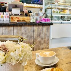 Wild Strawberry Café - Wild Strawberry with a latte and croissant inside seating.