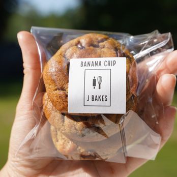 J Bakes - a hand holding a bag of cookies - Desserts Near Me J Bakes - a hand holding a bag of cookies - Desserts Near Me
