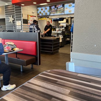 Carl's Jr - a woman sitting at a table in a restaurant - Burgers Near Me - Las Cruces, New Mexico Carl's Jr - a woman sitting at a table in a restaurant - Burgers Near Me - Las Cruces, New Mexico