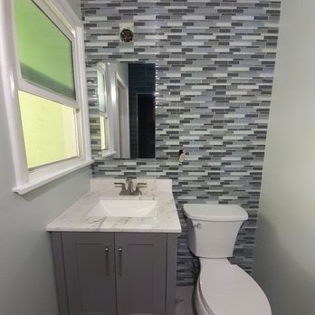 MC Construction & Design - A newly tiled vanity wall with new vanity, toilet, medicine cabinet, and fixtures. MC Construction also painted the walls and window trim. - General Contractors Near Me - Encino, California MC Construction & Design - A newly tiled vanity wall with new vanity, toilet, medicine cabinet, and fixtures. MC Construction also painted the walls and window trim. - General Contractors Near Me - Encino, California