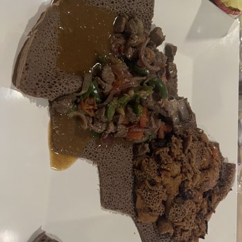 Gursha Ethiopian Restaurant - Injera (the flatbread) with Tibs (a steak stew) on the left and Quanta firfir (on the right, spicy beef jerky) - Ethiopian Near Me - Las Vegas, Nevada