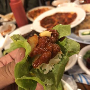 Sam Won Garden Restaurant - Spicy Pork on a lettuce wrap, topped with a garlic, if you don't eat kbbq this way, start doing it. It's better to eat this way. - Korean Near Me - Jacksonville, Florida Sam Won Garden Restaurant - Spicy Pork on a lettuce wrap, topped with a garlic, if you don't eat kbbq this way, start doing it. It's better to eat this way. - Korean Near Me - Jacksonville, Florida