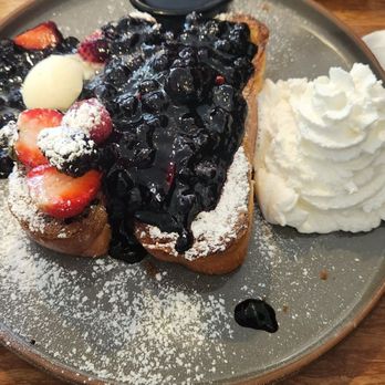 Eight AM - French toast with berries and side of crispy Applewood bacon. A little heavy on the berry action for me. Scrap it off and enjoy - New American Near Me - San Francisco, California