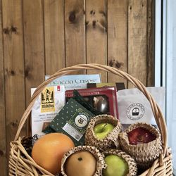 Sympathy gift basket filled with fresh fruits, savory treats and sweet chocolate
