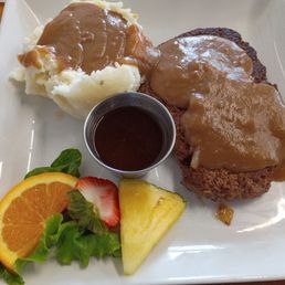 Hamburger steak with grilled onions and mashed potatoes with brown gravy. A side of au jus. Comes with a dinner salad (not pictured). Hamburger steak with grilled onions and mashed potatoes with brown gravy. A side of au jus. Comes with a dinner salad (not pictured).