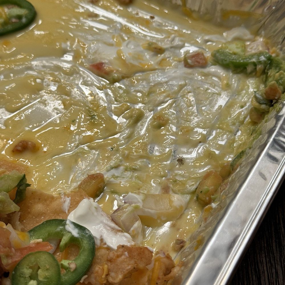 Grab N Go Tacos - Personal Nachos (eaten half way, with spider) - Tex-Mex Near Me - Sugar Land, Texas Grab N Go Tacos - Personal Nachos (eaten half way, with spider) - Tex-Mex Near Me - Sugar Land, Texas