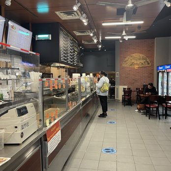 Kitchen Paradise - a man standing in a restaurant - Chinese Near Me - New York, New York