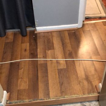 Empire Today - Spacer between kitchen and hallway ripped up by installer. Glue and broken wood lays all over the floor. - Carpet Installation Near Me