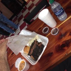 Boondocks Barbeque - BBQ ribs with slaw, bun, and peach cobbler, and water to drink.