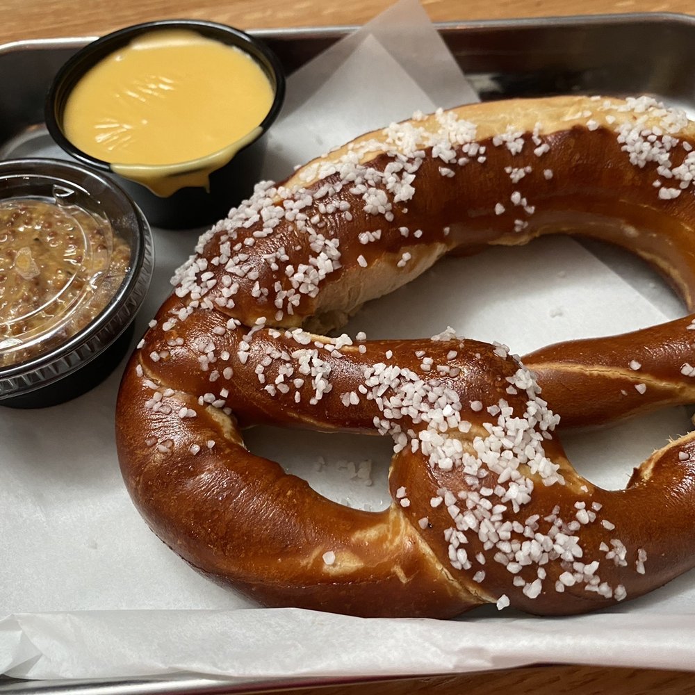Pretzel with cheese sauce and mustard Pretzel with cheese sauce and mustard