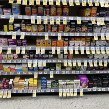Walgreens - Shelves in Walgreens filled with a variety of dietary supplements, vitamins, and health products. The products are organized in multiple rows, with labels and price tags visible. The items include multivitamins, immune support, and other health-related supplements, arranged neatly for customer browsing. The store floor is visible at the bottom of the image, showing a typical retail setting. - Cosmetics & Beauty Supply Near Me - Severna Park, Maryland