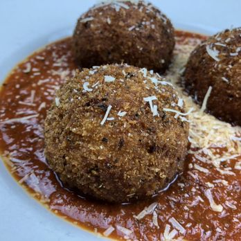 Pomodoro - Housemade Arancini; cheesy Italian rice balls in our pomodoro sauce. - Italian Near Me - Loves Park, Illinois Pomodoro - Housemade Arancini; cheesy Italian rice balls in our pomodoro sauce. - Italian Near Me - Loves Park, Illinois