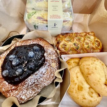 Tous Les Jours - Clockwise - egg salad sandwich with turkey ham, spinach & cheese pastry, potato & cheese bread, and blueberry pastry - Bakeries Near Me - Chantilly, Virginia