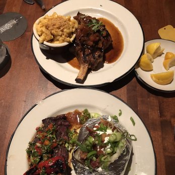 Moonshine Grill - Hanger steak with baked potato and pork chop with Mac and cheese - Southern Near Me - Austin, Texas
