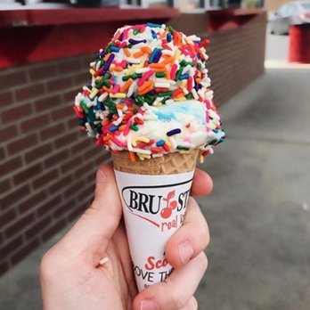 Bruster's Real Ice Cream - a hand holding an ice cream cone with sprinkles - Desserts Near Me - Woodstock, Georgia Bruster's Real Ice Cream - a hand holding an ice cream cone with sprinkles - Desserts Near Me - Woodstock, Georgia